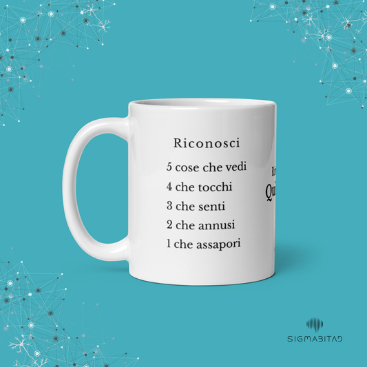 Tazza Qui e Ora SigmaBitAd in ceramica bianca, lato testuale con esercizio di grounding 5-4-3-2-1 in forma scritta.